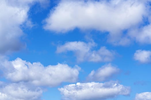 White cumulus clouds on blue sky background, natural phenomenon background and texture