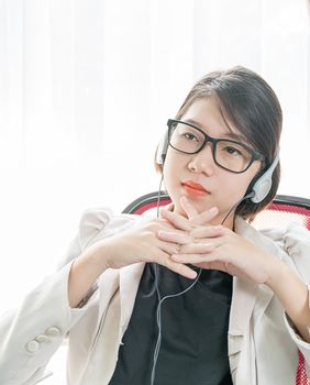 Teenage girl short hair relaxed after working on laptop while sit near window at home office