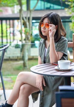 Pretty woman sitting in a cafe terrace with coffee cup