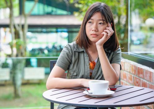 Pretty woman sitting in a cafe terrace with coffee cup