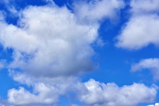 White cumulus clouds on blue sky background, natural phenomenon background and texture