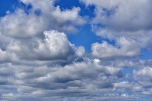White cumulus clouds on blue sky background, natural phenomenon background and texture