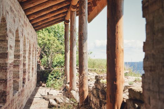 Fragment of the old fortress wall with windows overlooking the sea coast. Sunny summer day