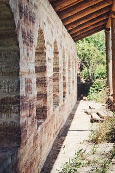 Fragment of the old fortress wall with windows overlooking the sea coast. Sunny summer day