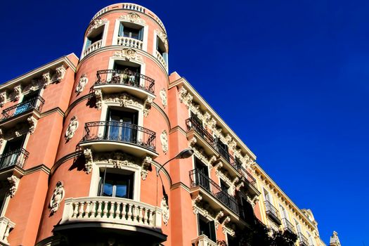 Old colorful and beautiful facades with vintage streetlight in Madrid streets in Spring.