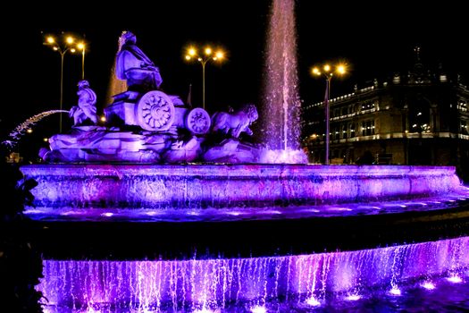 Beautiful Cibeles fountain illuminated in purple in the International Women's Day