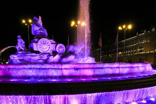 Beautiful Cibeles fountain illuminated in purple in the International Women's Day