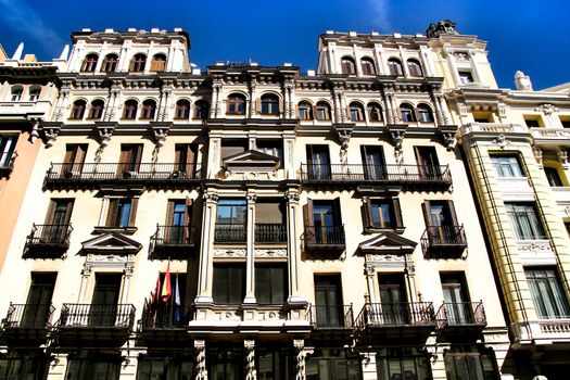 Old colorful and beautiful facades with vintage streetlight in Madrid streets in Spring.