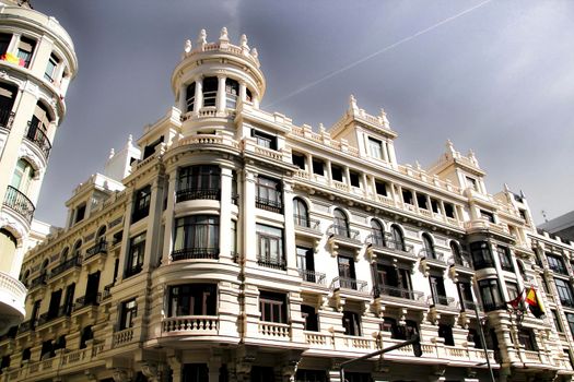 Old colorful and beautiful facades with vintage streetlight in Madrid streets in Spring.