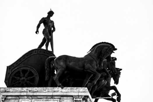 Beautiful quadriga statue on the roof of a building in Madrid