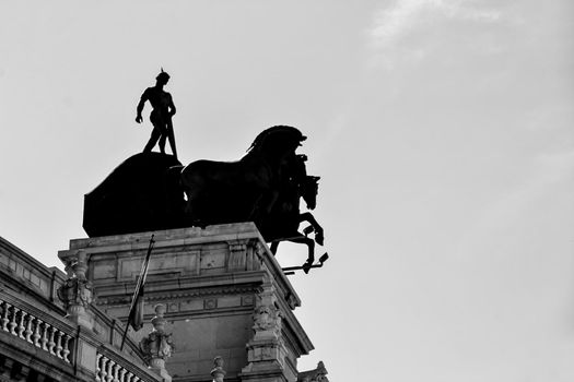 Beautiful quadriga statue on the roof of a building in Madrid