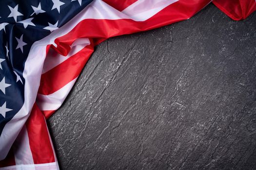 Concept of U.S Independence day or Memorial day. National flag over dark slate table background.