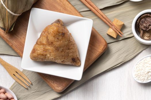 Zongzi. Delicious traditional rice dumpling food for Dragon Boat Duanwu Festival over wooden table background top view.