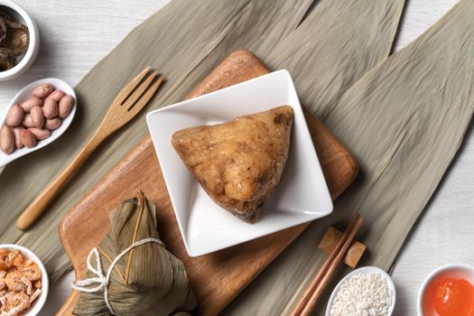 Zongzi. Delicious traditional rice dumpling food for Dragon Boat Duanwu Festival over wooden table background top view.