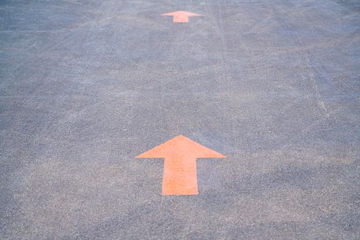 orange arrows are signs on the asphalt of the road. High quality photo