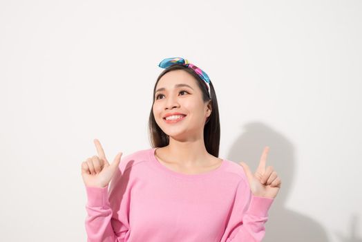 young attractive asian woman who points to the finger