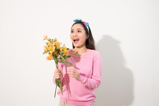 Lifestyle leisure international women's day concept. Close up portrait of lovely cute adorable excited delightful attractive woman holding flowers isolated on white background