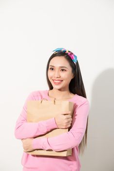 Closeup of young and stylish girl holding blank craft package, mock-up