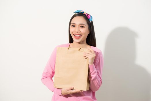 Closeup of young and stylish girl holding blank craft package, mock-up