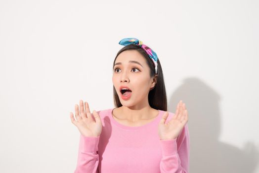 Asian Young Woman in Surprising Emotion, Face Look up above with opened mouth and hands, Emotional of Female Concept, Front view