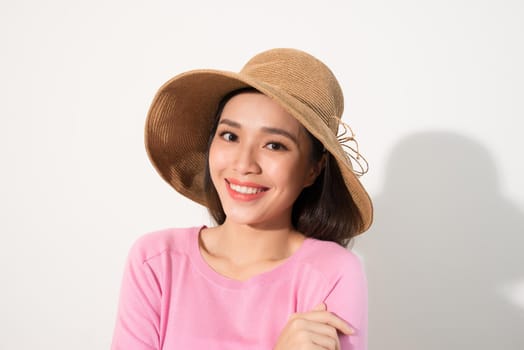 Portrait of a beautiful woman in a straw hat. Laughing girl. Summer time