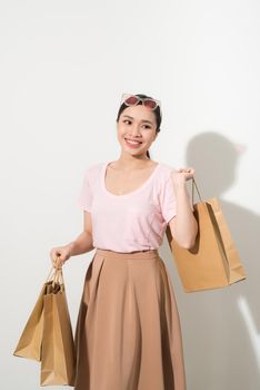 young woman with purchases on a white background, fashion, beauty
