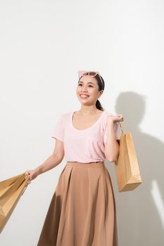 young woman with purchases on a white background, fashion, beauty