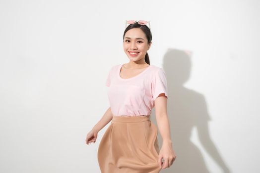 Magnificent girl dancing with smile in white studio. Indoor portrait of inspired caucasian lady in romantic outfit expressing happy emotions.