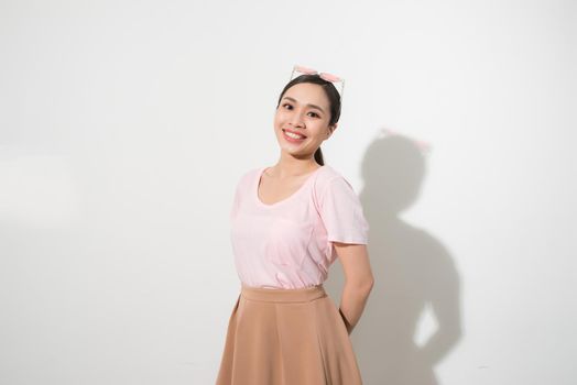 Magnificent girl dancing with smile in white studio. Indoor portrait of inspired caucasian lady in romantic outfit expressing happy emotions.