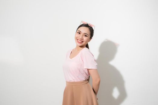 Magnificent girl dancing with smile in white studio. Indoor portrait of inspired caucasian lady in romantic outfit expressing happy emotions.