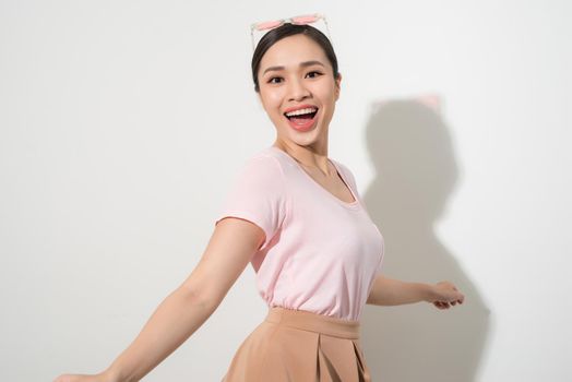 Magnificent girl dancing with smile in white studio. Indoor portrait of inspired caucasian lady in romantic outfit expressing happy emotions.