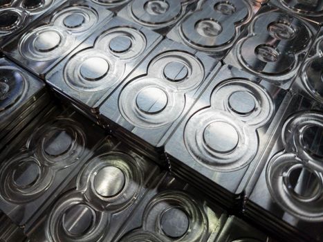 shiny metal machined digit 8 plates tiled tightly - close-up full frame background