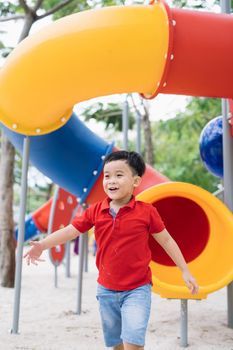 Cute little boy having fun on a playground outdoors in summer