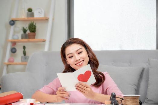 Valentine day theme. Beautiful romantic woman making present for her couple