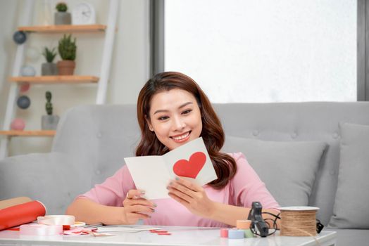 Valentine day theme. Beautiful romantic woman making present for her couple