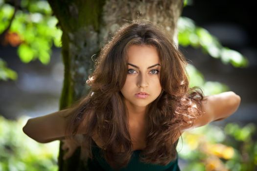 Portrait of a young woman on forest background