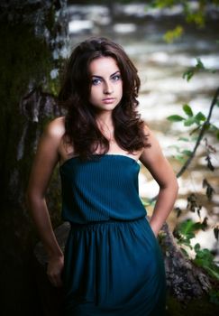 Beautiful sensual young woman in the wood near the river