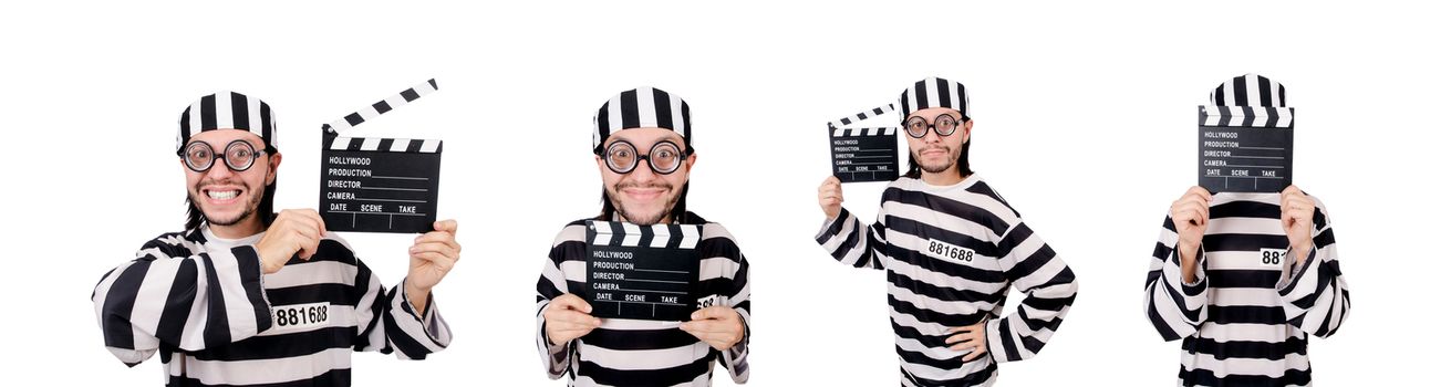 Funny prison inmate with movie board isolated on white