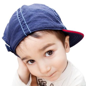 Portrait of a little boy with cunning eyes wearing a cap