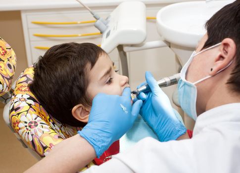  little boy healing his teeth in dentist office