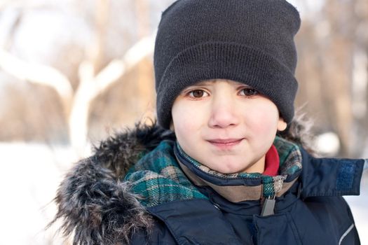 Winter portrait of  boy in snow background