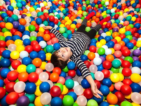 Little boy playing with balls