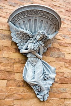 Fairy statue and fountain basin decorated on the wall