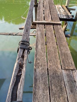 Old wooden pier beside drainage canal