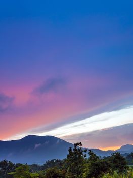 Vivid color of Sky and Clouds drifting over the forest mountain in evening time