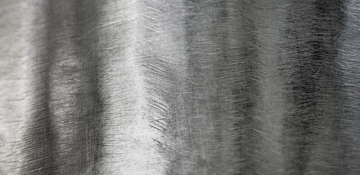 Texture of shiny surface and scratched on stainless steel round bar, industrial grunge background