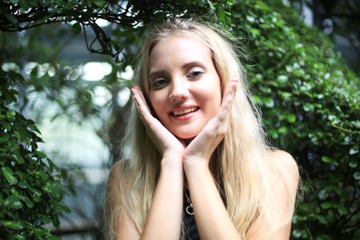 Portrait of Beautiful blonde hair girl on black dress as fashion portrait outdoor