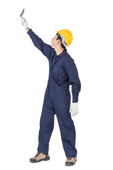 Portrait of a workman with blue coveralls and hardhat in a uniform holding steel trowel on white background with clipping path