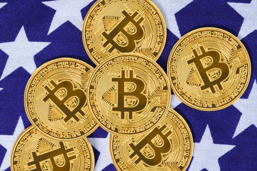 Crypto currency concept. Gold Bitcoin coin on flag of United States of America USA