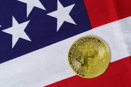 Crypto currency concept. Gold Bitcoin coin on flag of United States of America USA